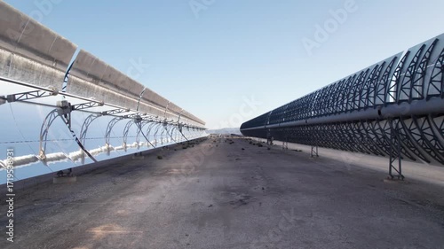 Solar thermal power plant with parabolic mirrors in a dry landscape. Renewable energy technology for clean electricity production and environmental sustainability.