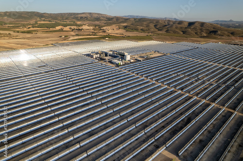 Fotografie Solar thermal power station with rows of parabolic trough mirrors reflecting sunlight