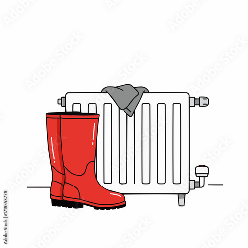 Red rain boots drying beside a radiator with a grey cloth  