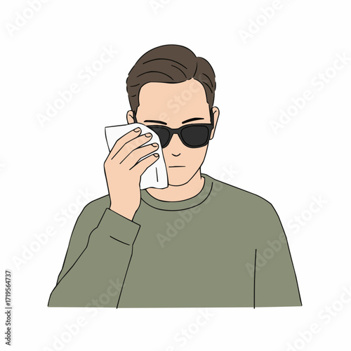 Man cleaning sunglasses with tissue while wearing casual clothing  