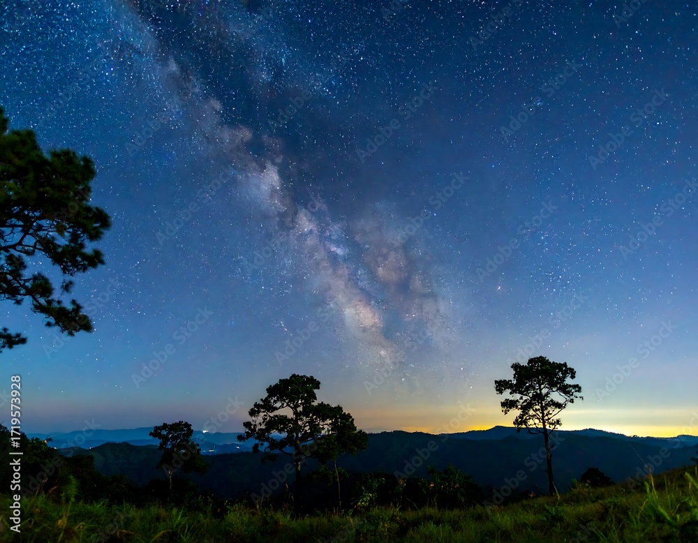 Fototapeta premium Milky Way over a mountain range at dawn