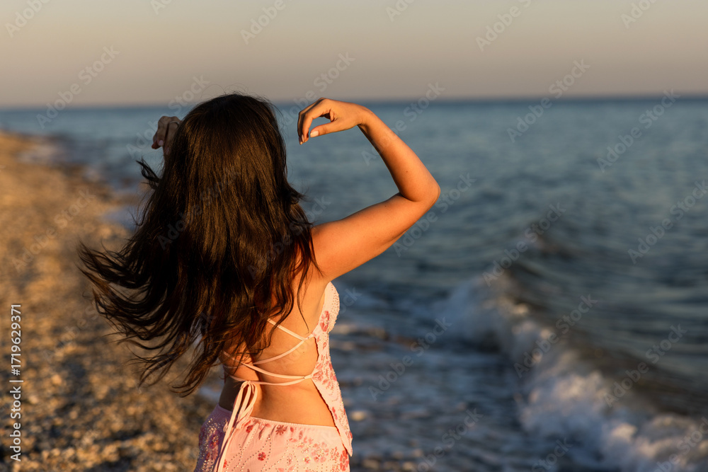 Naklejka premium A Serene Beach Dance Happening at Sunset, a Unique Experience of Bliss and Beauty for All