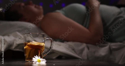 Relax and unwind with a warm cup of chamomile tea as soft night lights create a calming atmosphere. Perfect for those seeking a natural remedy for insomnia and stress relief.