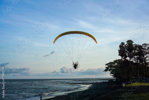 Paramotor is a type of aerospace sport with a special parachute and using a compact engine. Paramotor at the beach.