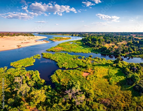 Aerial view of a river winding through lush green landscapes