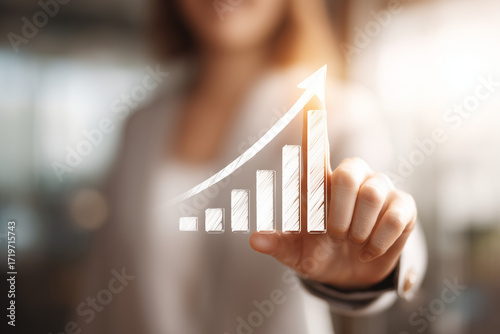 professional pointing toward bar graph with upward arrows