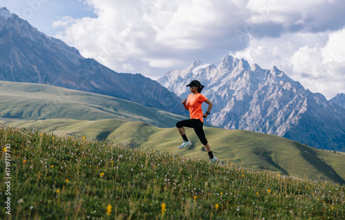 Female runner running on the high altitude grassland mountain top