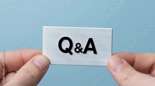 Q&A card held by hands with blue background symbolizing question answer concept communication information exchange small white card held by two hands