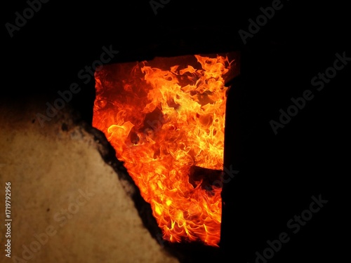 Flame, fire, building fire, intensity of fire inside a room, room for fire training for firefighters, damage caused by fire.