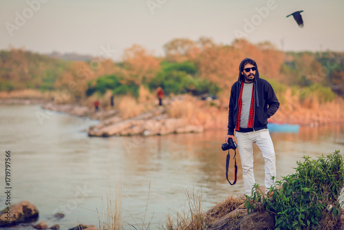 Professional Photographer Standing by Riverside with DSLR Camera – Outdoor Travel and Lifestyle Concept