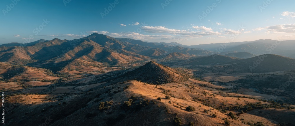 Obraz premium Cinematic Landscape Theme: Drone aerial of rolling hills painted in patchwork fields at sunset, aerial backdrop