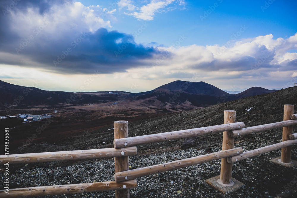 Fototapeta premium Scenic View of Mountain Landscape with Sun Rays and Wooden Fence at Sunset