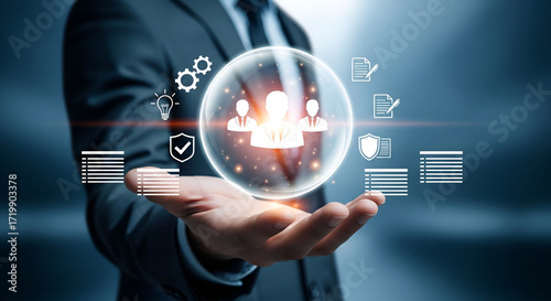 Businessman holding a glowing digital sphere with team members and business icons in a futuristic setting