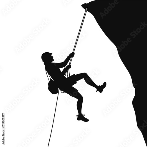 Climber rappelling down cliff silhouette