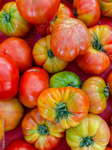 Assorted colorful tomatoes in crates at farmer market