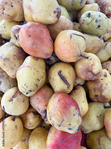 Fresh yellow tropical fruits stacked at outdoor market