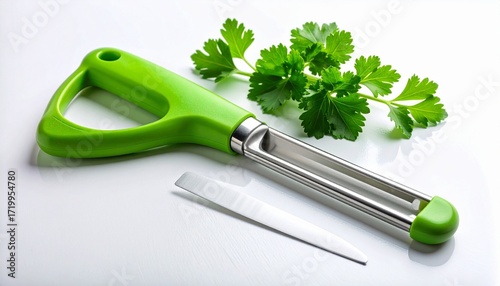 Green-handled vegetable peeler with stainless blade beside fresh parsley on white surface—culinary utility meets organic vibrancy in minimalist kitchen tool and ingredient composition.
