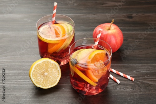 Tasty punch in glass and fresh fruits on wooden table. Refreshing drink