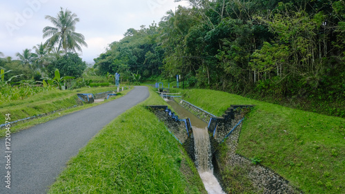 Rural Road Irrigation System with Green Landscape.