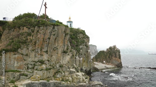 Vladivostok Peninsula. Seagulls circle over the church