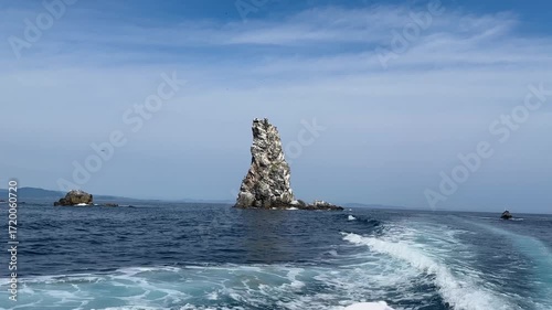 Sailing on a yacht among the rocks. Sea rocks in the sea. Putyatin Island Vladivostok.
