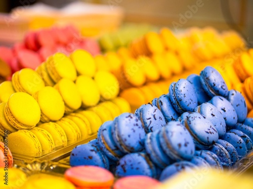 Assorted macarons in a Paris pâtisserie display, France—colorful French desserts behind glass, an inviting sweet moment for travel and food lovers across Europe.