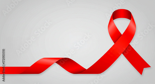 Red ribbon representing AIDS awareness on a light gray background.