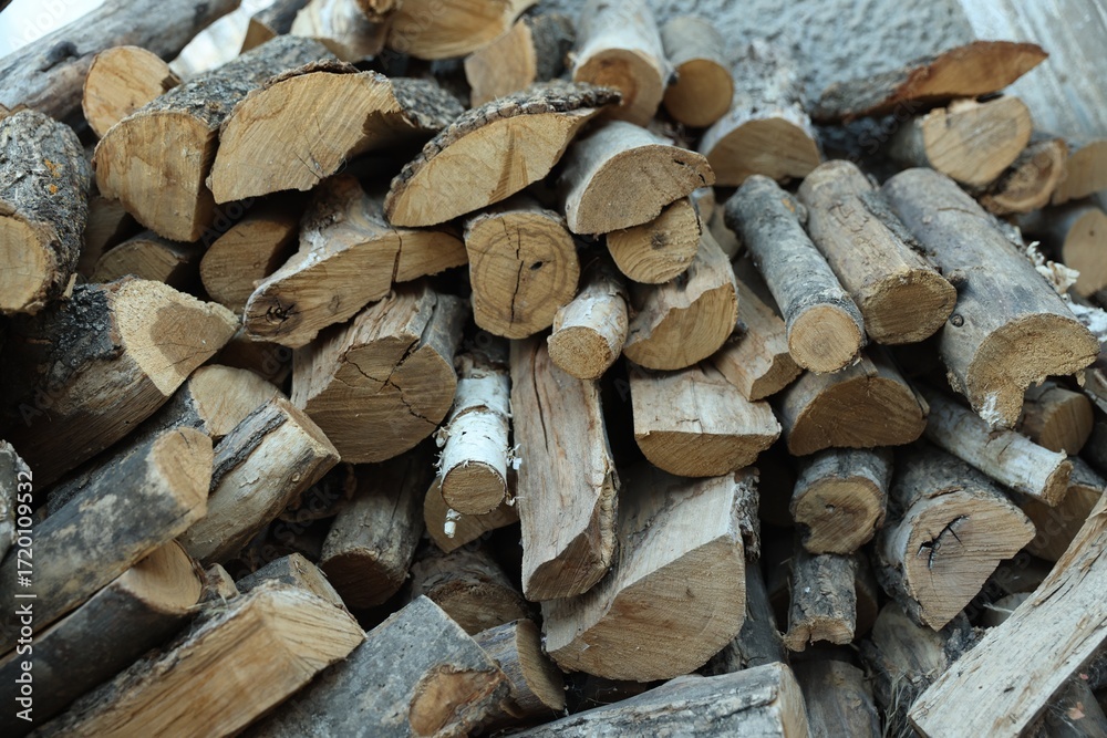 Fototapeta premium Pile of cut firewood outdoors, closeup view