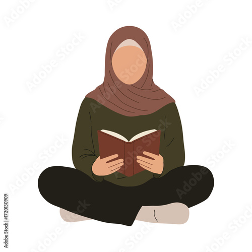 A person wearing a hijab is sitting cross-legged and reading a book with focus.