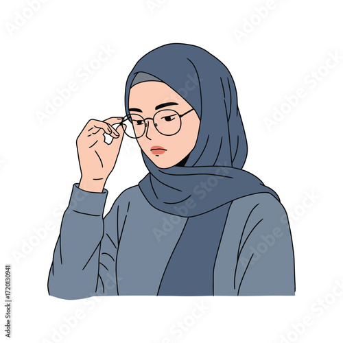 A young woman wearing a hijab adjusts her glasses.