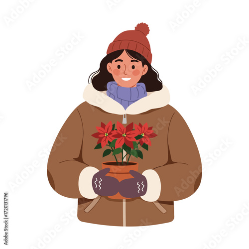 Woman holding a poinsettia plant in winter clothing.