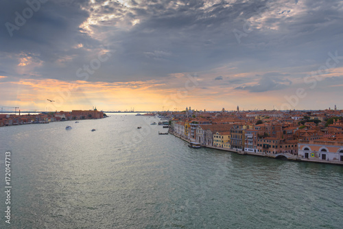 Aerial sunset view of the Giudecca Canal with the cityscape of Venice, Italy.