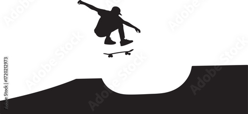 Black silhouette of a skateboarder performing a trick in mid air above a ramp black and white jump