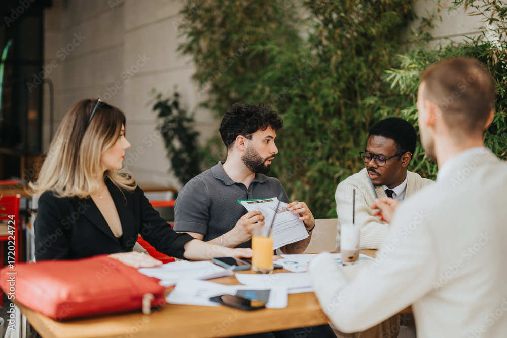 Fototapeta premium A group of four people having a professional meeting in an outdoor setting involving documents and conversation, exemplifying a collaborative business environment and teamwork.