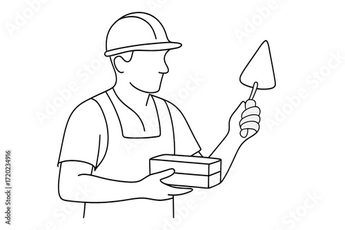 Construction worker holding brick and trowel in safety helmet  