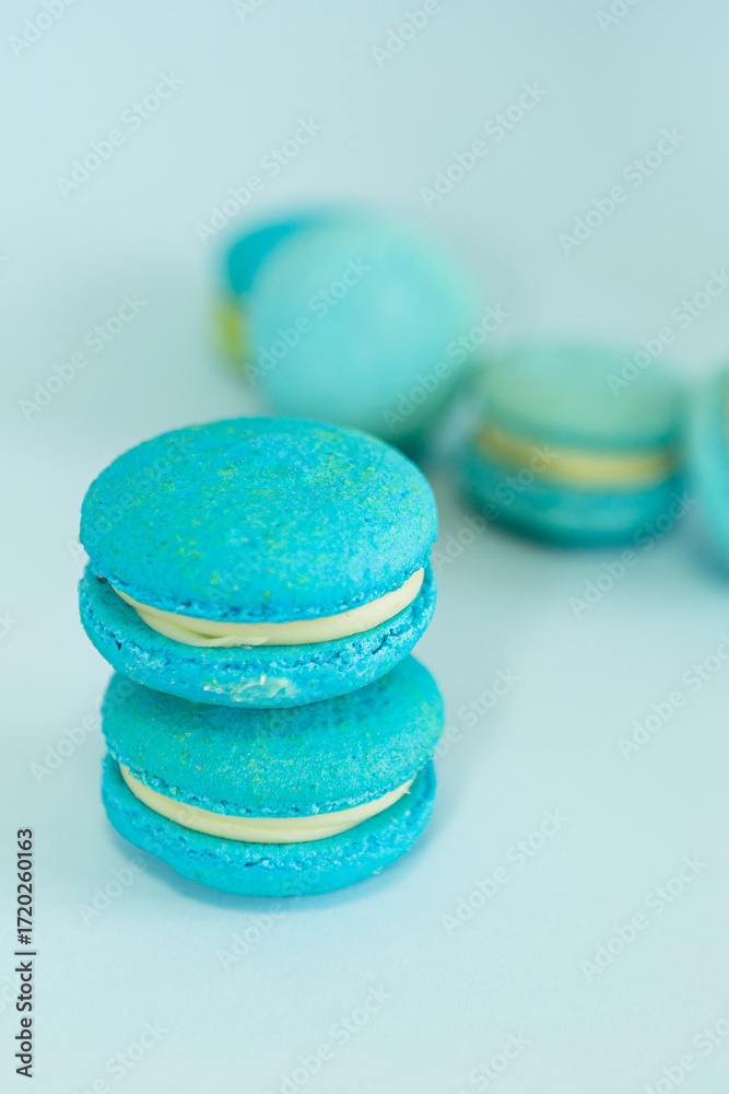 Fototapeta premium few of a blue colored macaroons on a flat blue background