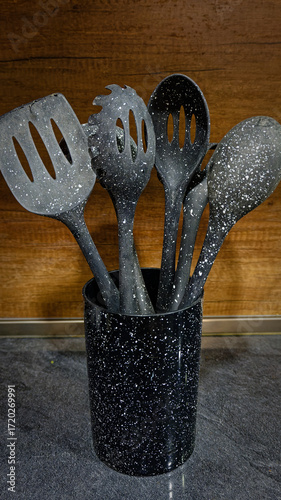 Used black with white dots plastic kitchen utensils