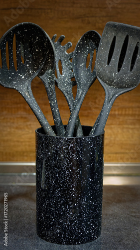 Used black with white dots plastic kitchen utensils