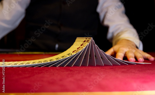 Croupier hands dealing cards on t blackjack poker table, gambling table with cards and chips. The croupier in the casino does a shuffle of cards. Person playing poker.