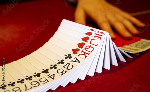Картината върху платно Croupier hands dealing cards on t blackjack poker table, gambling table with cards and chips