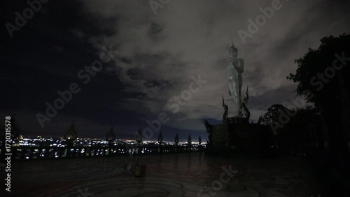 Video background of Chonburi city viewpoint. At the Samnaksong Khao Phra Khru viewpoint in the Sri Racha Thailand,a beautiful Naga statue and a white Buddha statue stand tall among the mountains.
