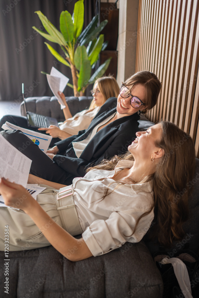 custom made wallpaper toronto digitalWomen in business attire resting on couch, enjoying a short office break after intense work