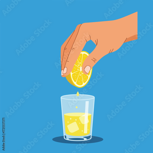 Hand squeezes lemon juice into glass with ice, on blue background