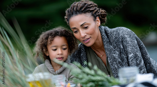 A nurturing scene of a mother and child enjoying a meal together outside, capturing the connection and warmth shared during intimate family moments in nature.