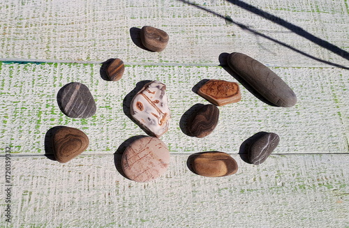 Sea stones on a wooden board, Mediterranean Sea
