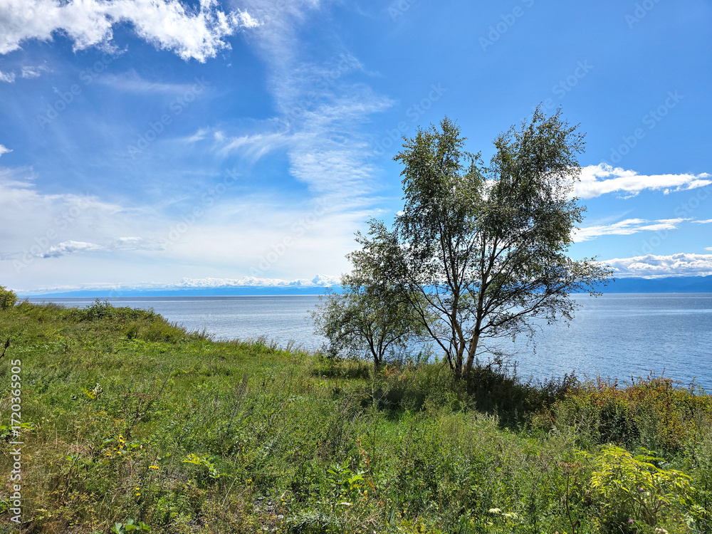Fototapeta premium clouds and rising sun rays over lake Baikal