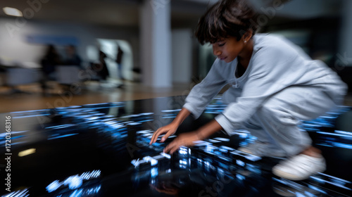 Wallpaper Mural A young child is engaging with glowing digital elements on the floor in a playful environment, highlighting curiosity, exploration, and the joy of learning through technology. Torontodigital.ca