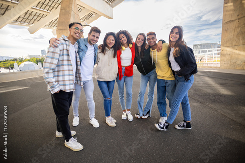 Wallpaper Mural Young diverse group of friends smiling at camera standing together outdoors. Friendship concept Torontodigital.ca
