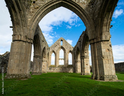Ruined stone church interior with arched windows