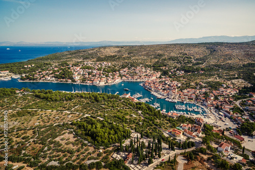Aerial view of Milna town and marina on Brac island, Croatia, with sailboats, old stone houses, and Mediterranean landscape